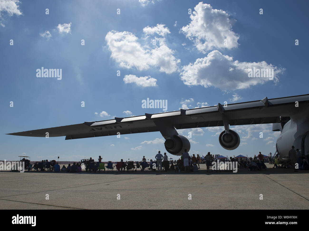 Visitors take refuge from the sun under the wing of a USAF C-5M Super Galaxy at the Air Show at Joint Base Andrews in Prince George's County, Maryland, September 18, 2015.  Photo by Molly Riley/UPI Stock Photo