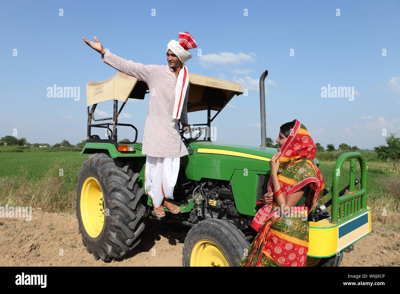 Farmer showing field to his wife Stock Photo - Alamy