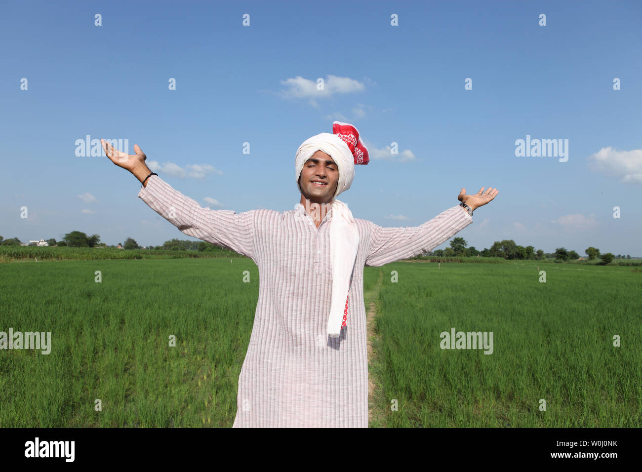 Indian farmer standing in a field Stock Photo - Alamy