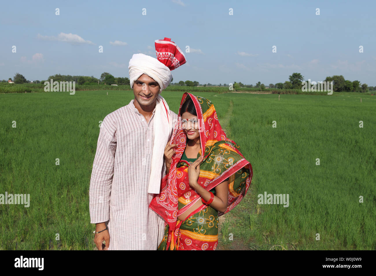 Portrait of a farmer standing with his wife in a field Stock Photo - Alamy