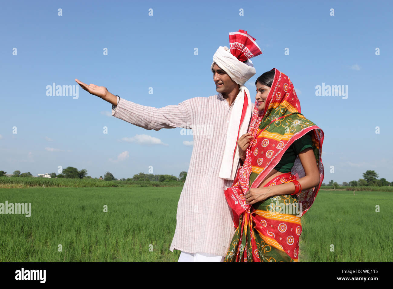Farmer showing field to his wife Stock Photo - Alamy