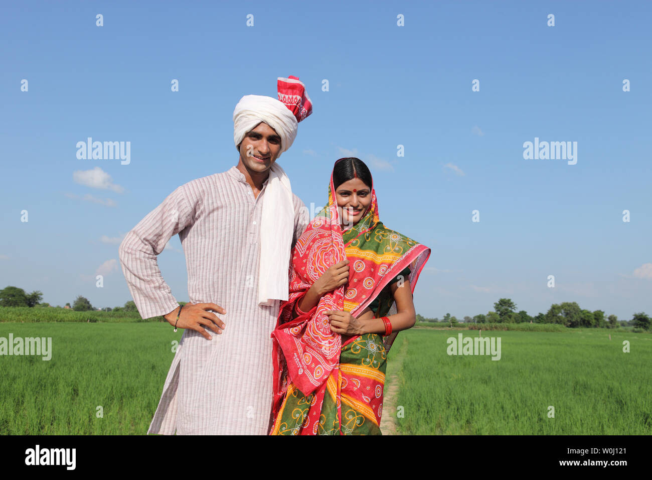 Portrait of a farmer standing with his wife in a field Stock Photo - Alamy