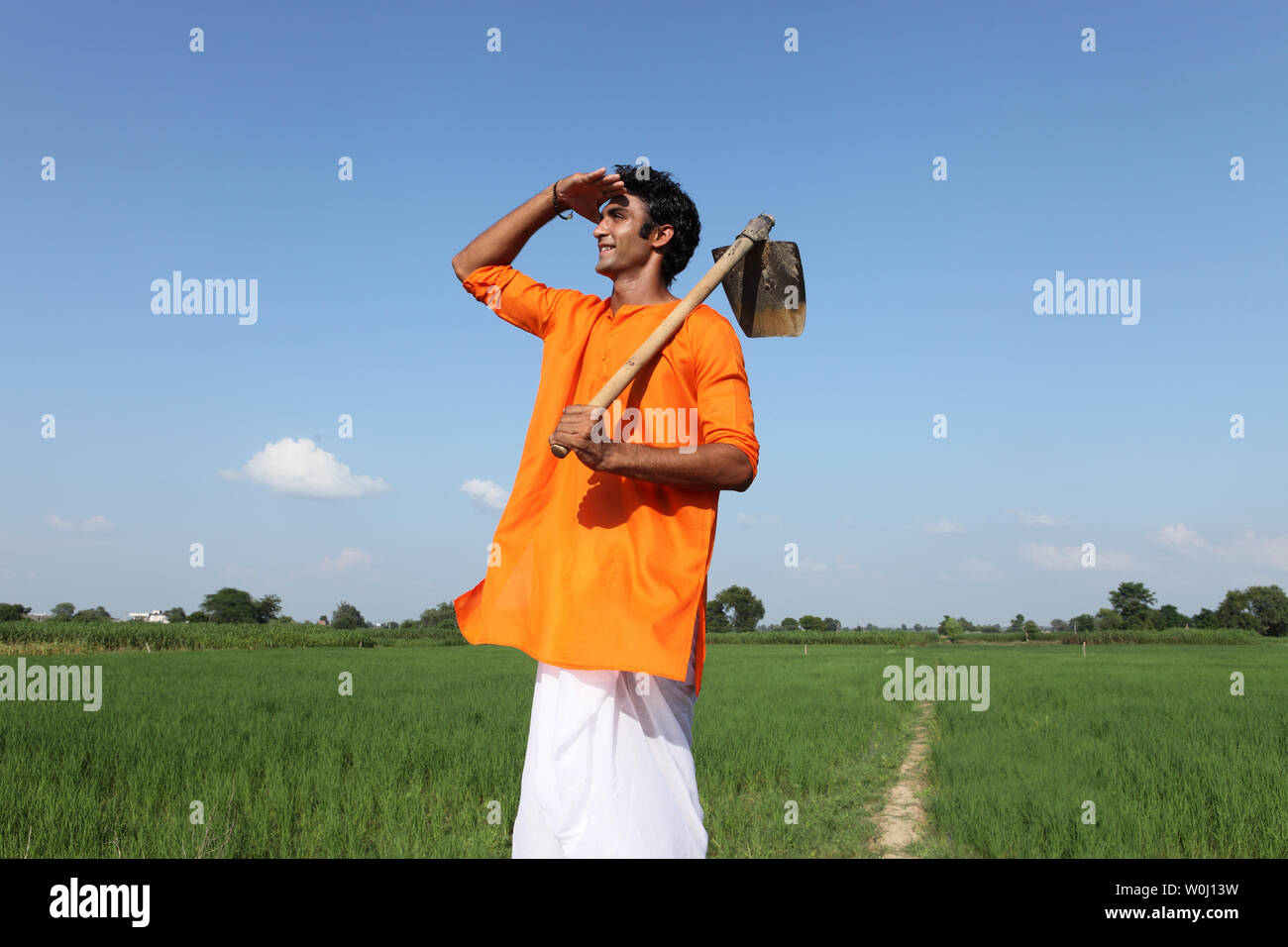 Indian farmer standing in a field Stock Photo - Alamy