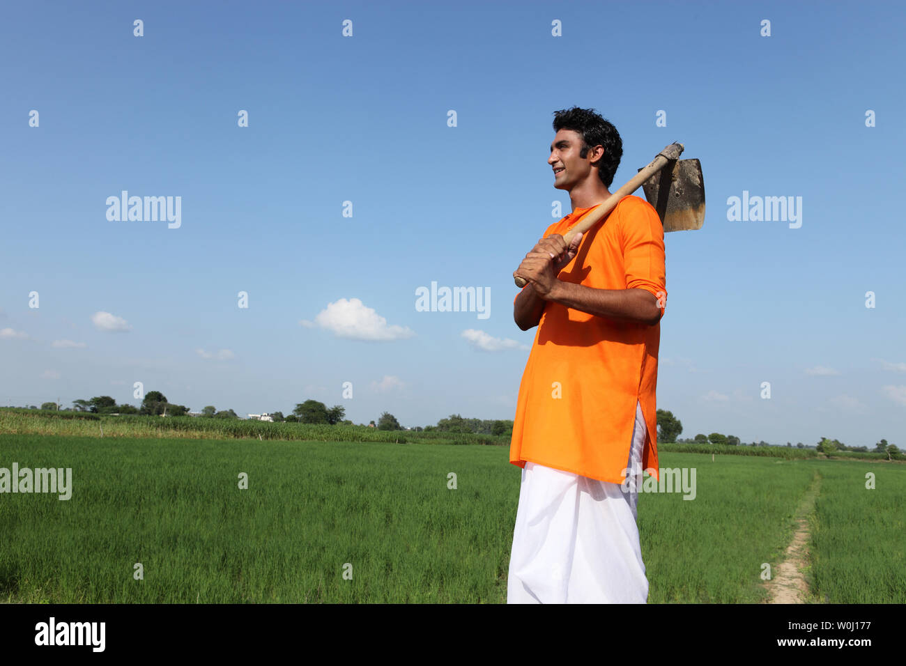 Indian farmer standing in a field Stock Photo - Alamy
