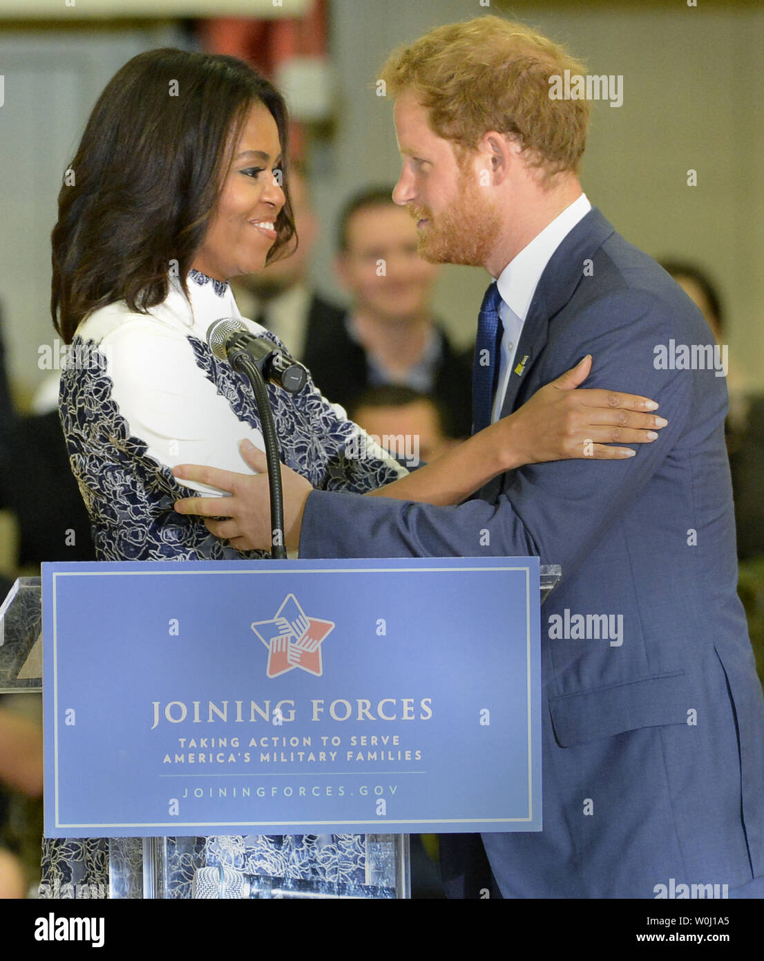 HRH Prince Harry (R) and First Lady Michelle Obama embrace prior to a basketball game by wounded service members, October 28, 2015, at Ft. Belvoir, Virginia. The event is a celebration of the Joining Forces Initiative and the upcoming 2016 Invictus Games in Orlando, Florida, in which wounded military personnel compete in sporting competition.       Photo by Mike Theiler/UPI Stock Photo