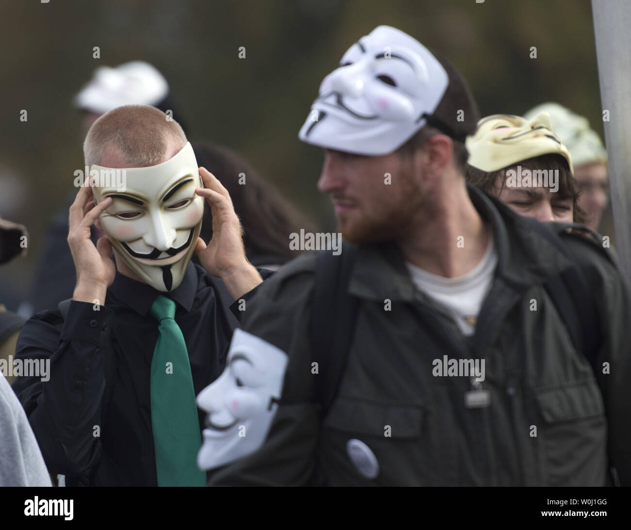 Demonstrators wearing Guy Fawkes masks prepare to march in the Million Mask March, an anti-establishment protest expected to take part today in over 670 cities worldwide, in Washington, D.C. on November 5, 2015. The march, allegedly organized by Anonymous, the “hacktivist” group linked to cyber-attacks against governments and multi-national corporations, aims at protesting government overreach and corporate greed, among other grievances. Photo by Kevin Dietsch/UPI Stock Photo