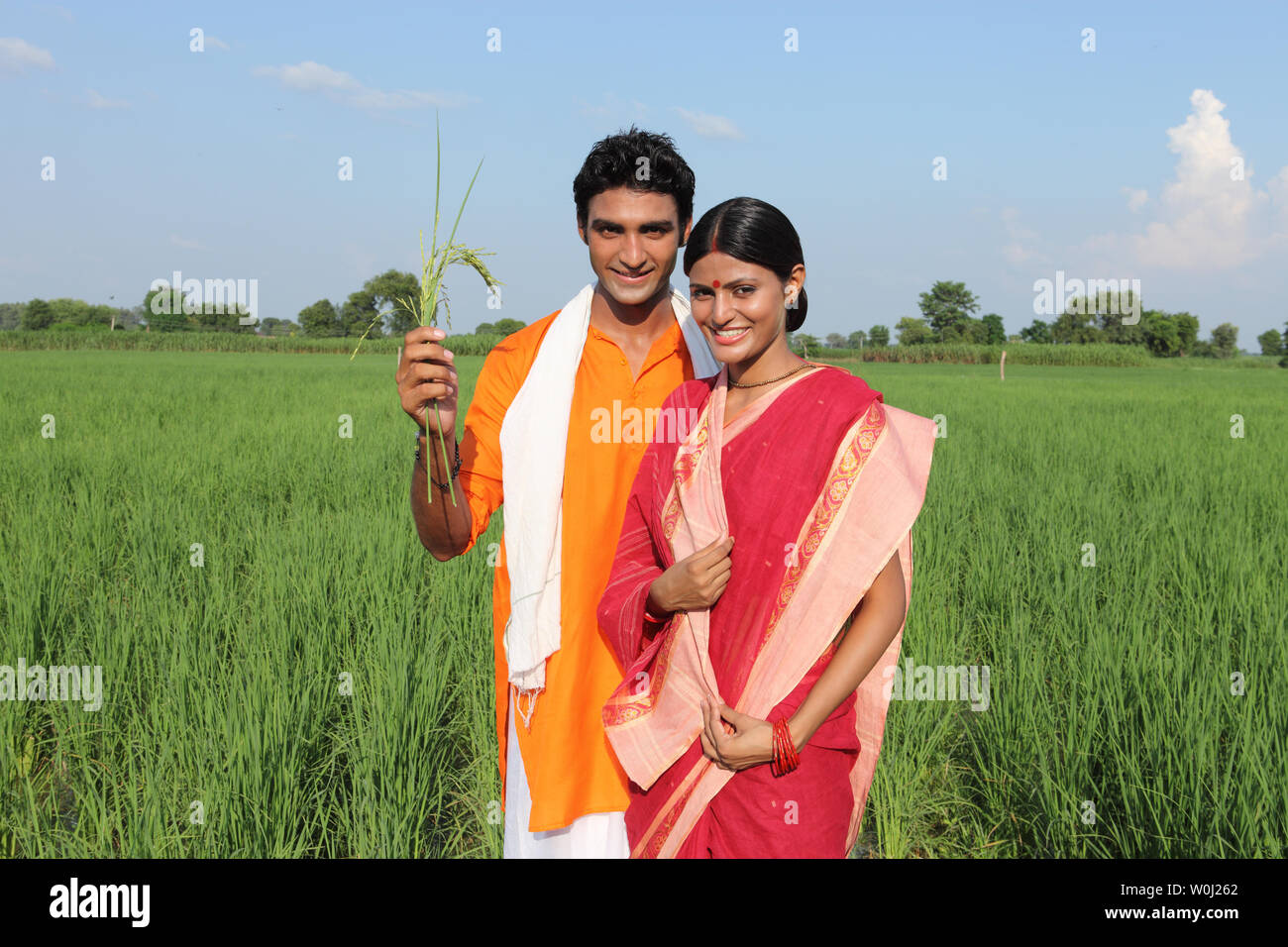 Portrait of a farmer standing with his wife in a field Stock Photo - Alamy