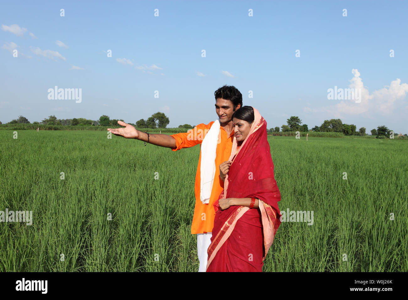 Farmer showing field to his wife Stock Photo - Alamy