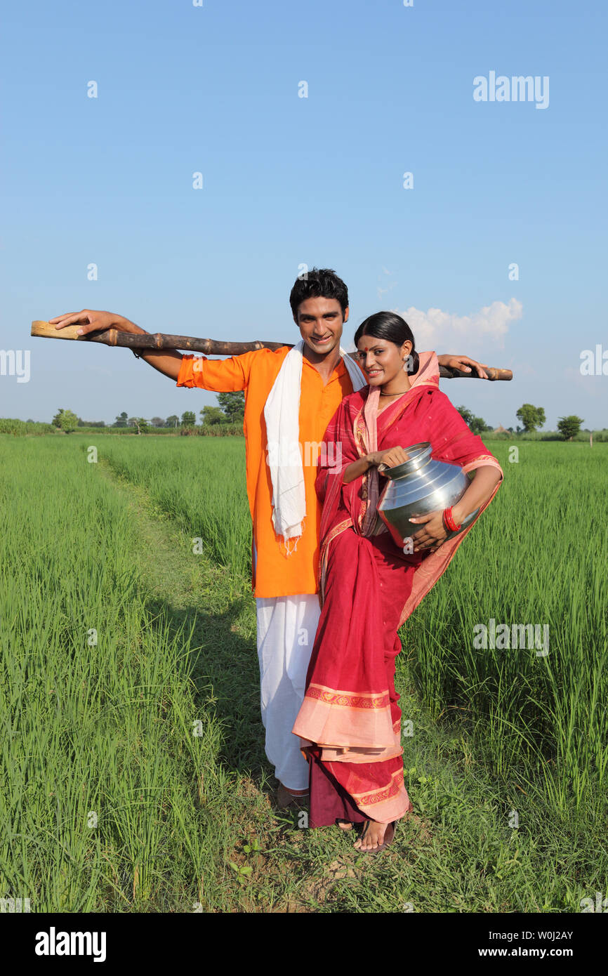 Farmer with his wife standing in a field Stock Photo - Alamy