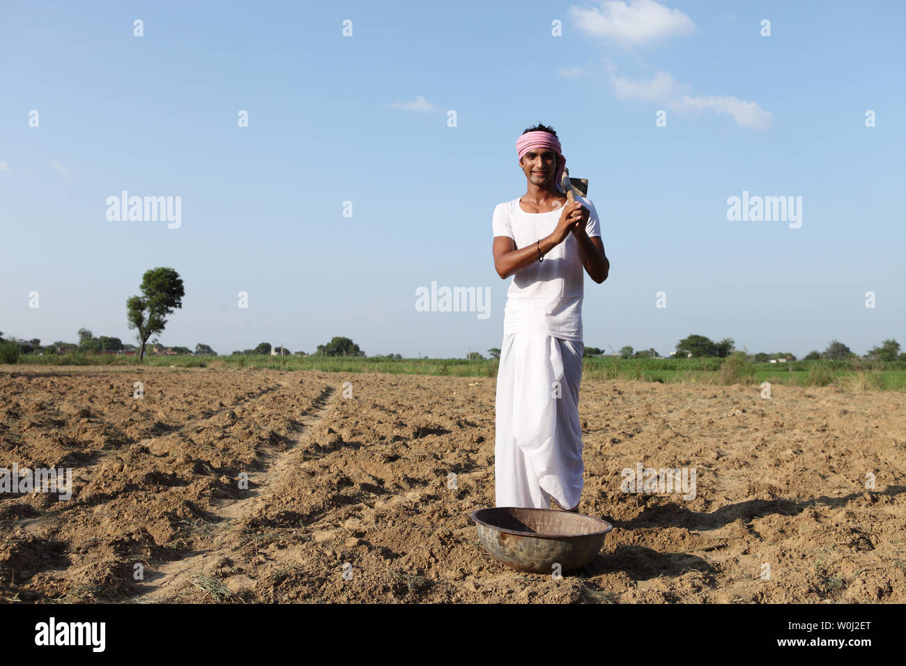 Indian farmer working in a field Stock Photo