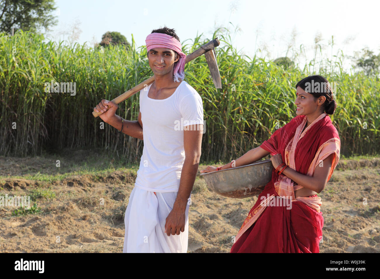 Farmer with his wife working in a field Stock Photo - Alamy
