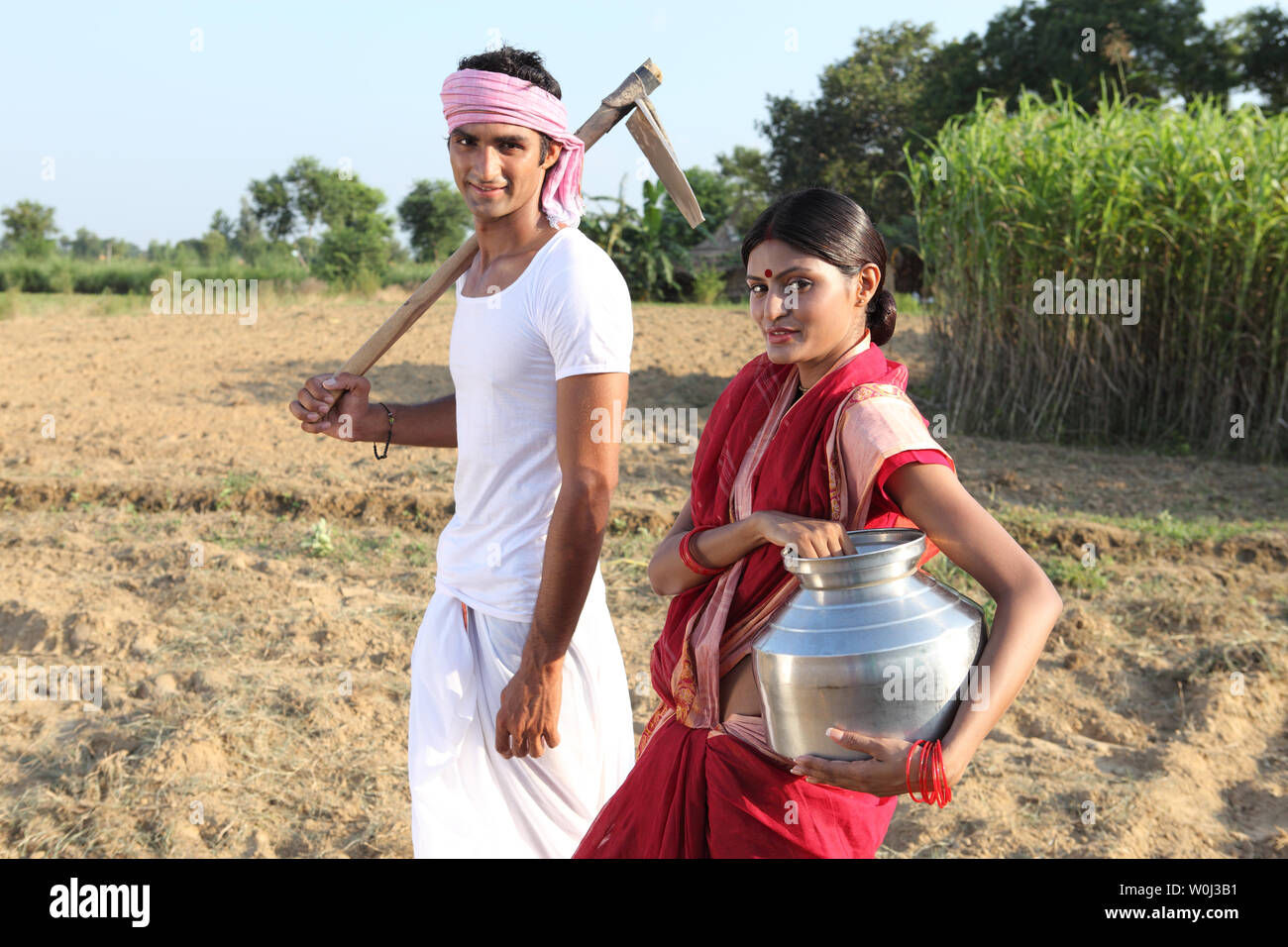 Farmer with his wife working in a field Stock Photo - Alamy