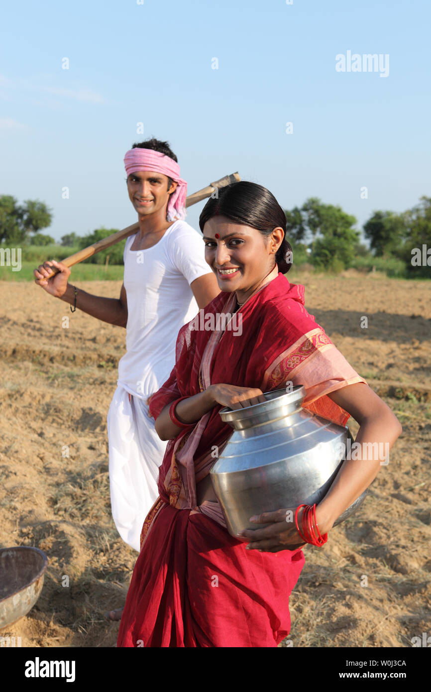 Farmer with his wife working in a field Stock Photo - Alamy