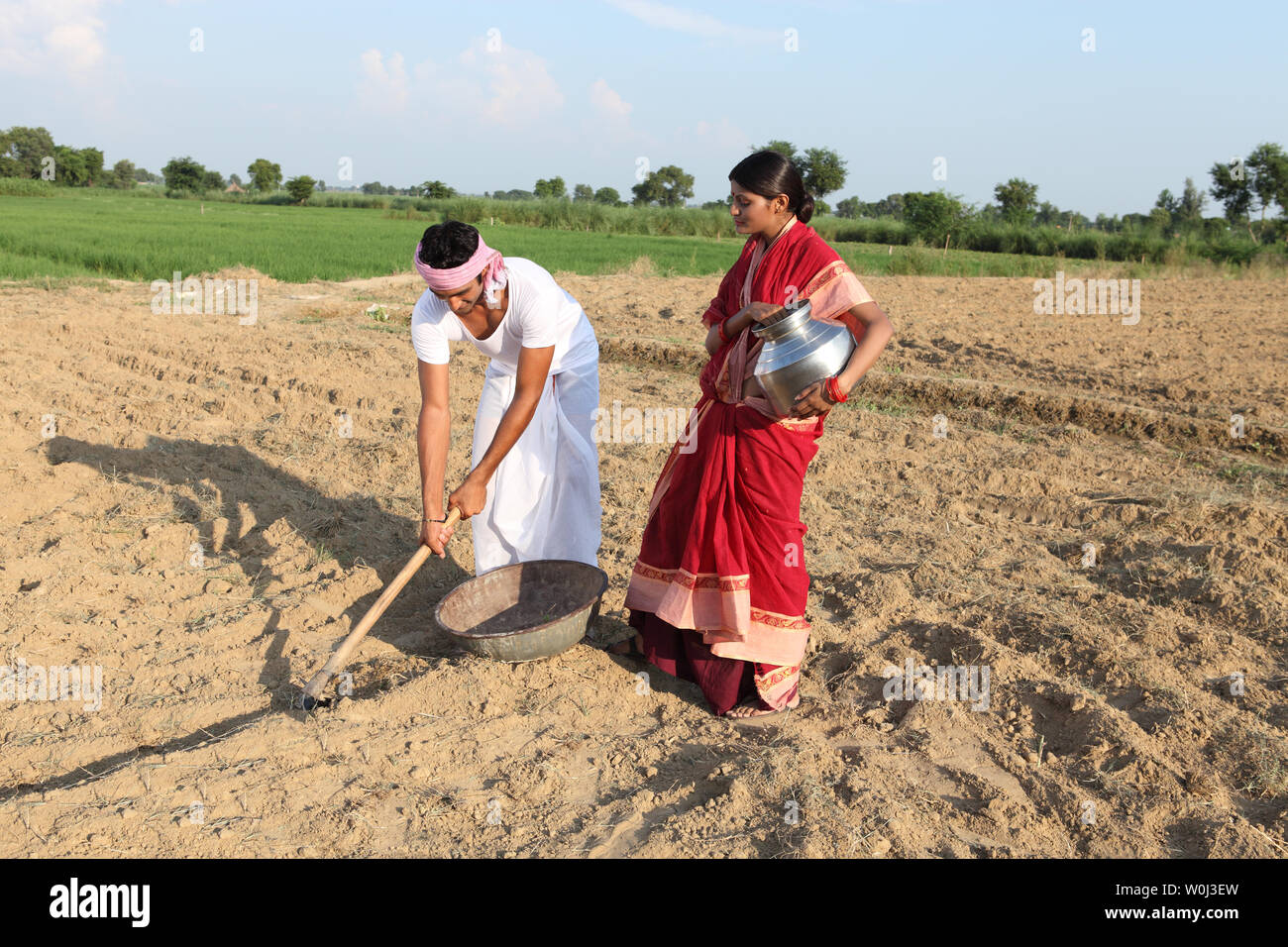 Farmer with his wife working in a field Stock Photo - Alamy