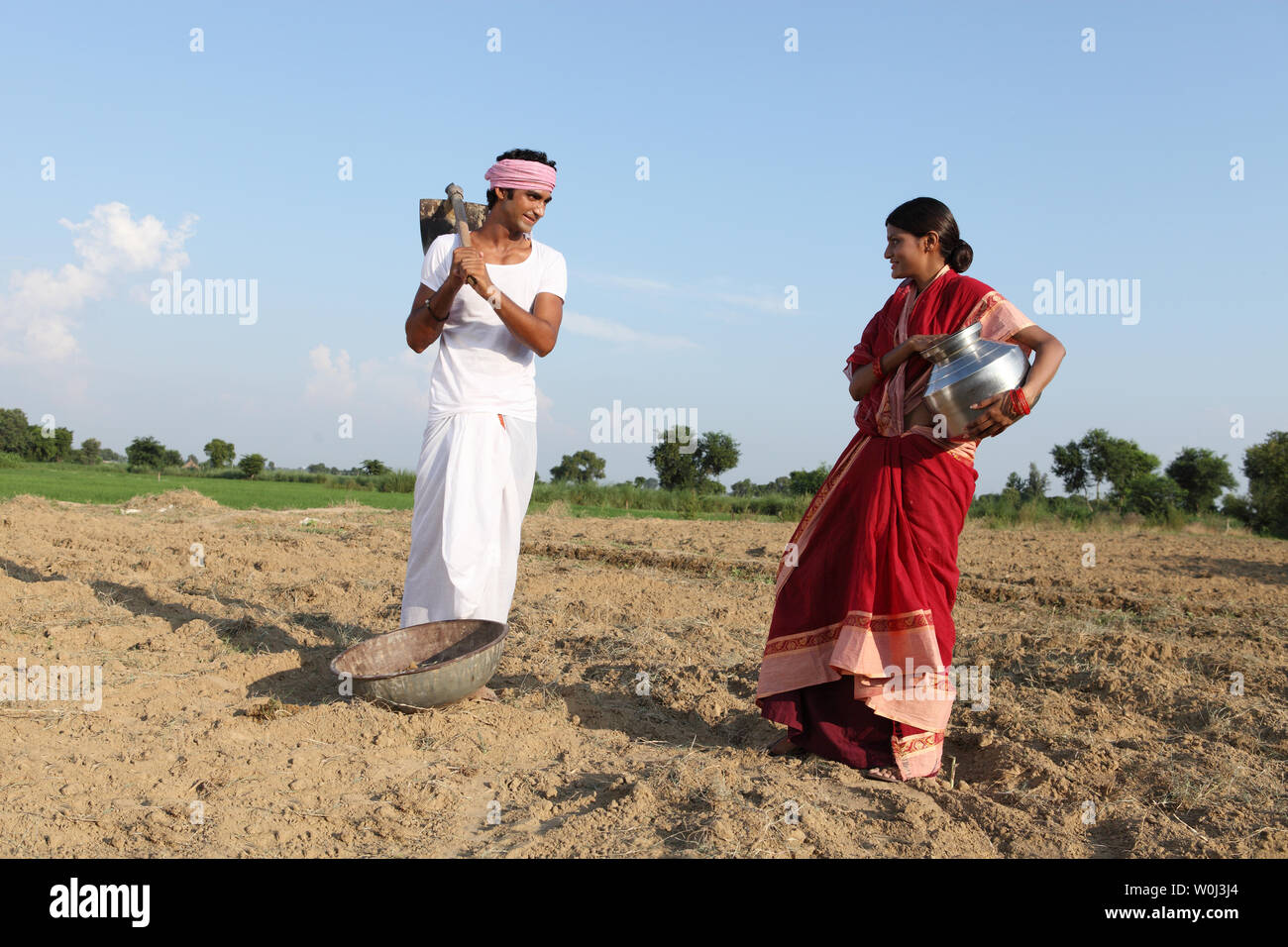 Indian farmer with his wife working in a field Stock Photo Alamy