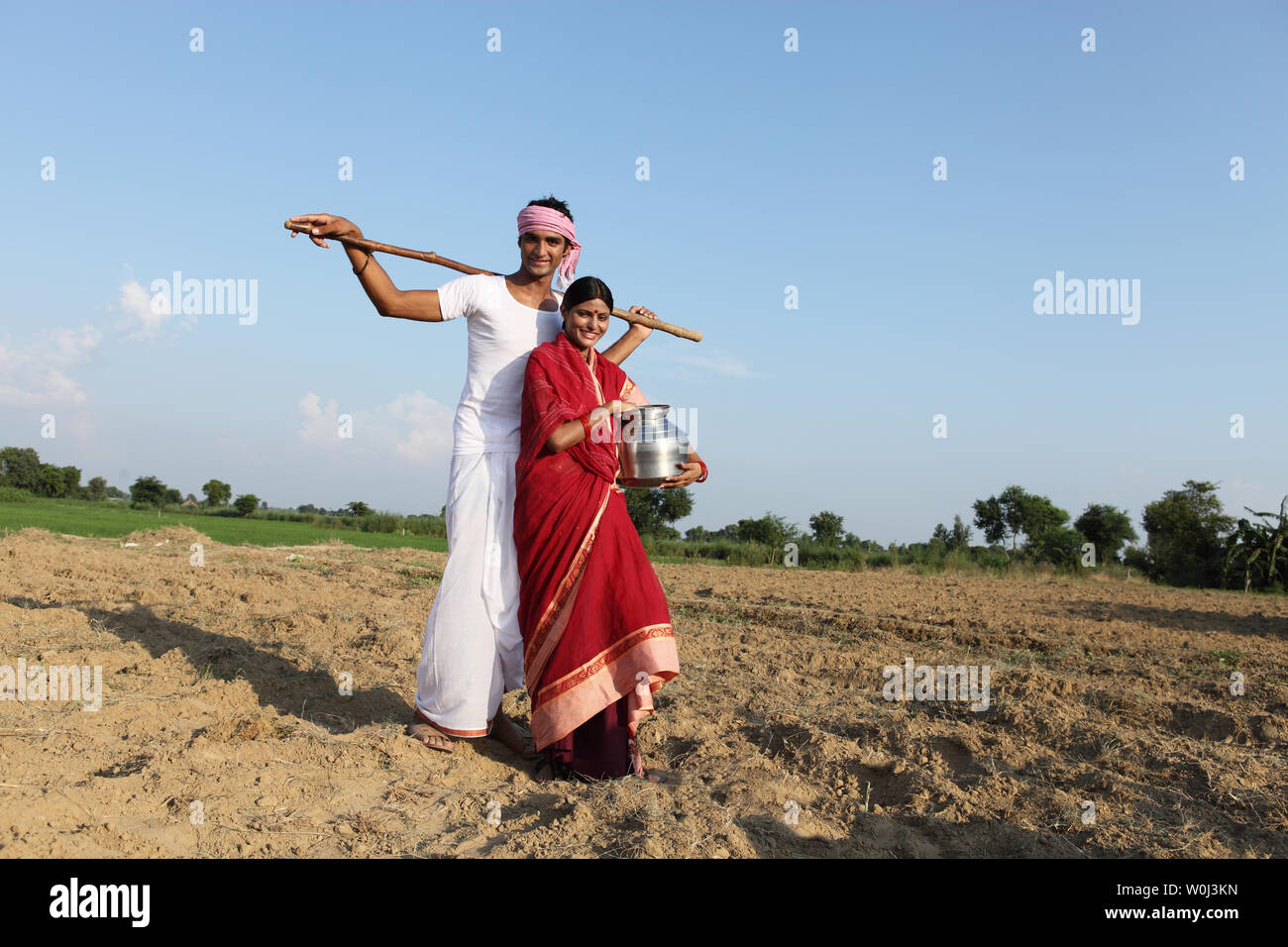 Farmer with his wife standing in a field Stock Photo - Alamy