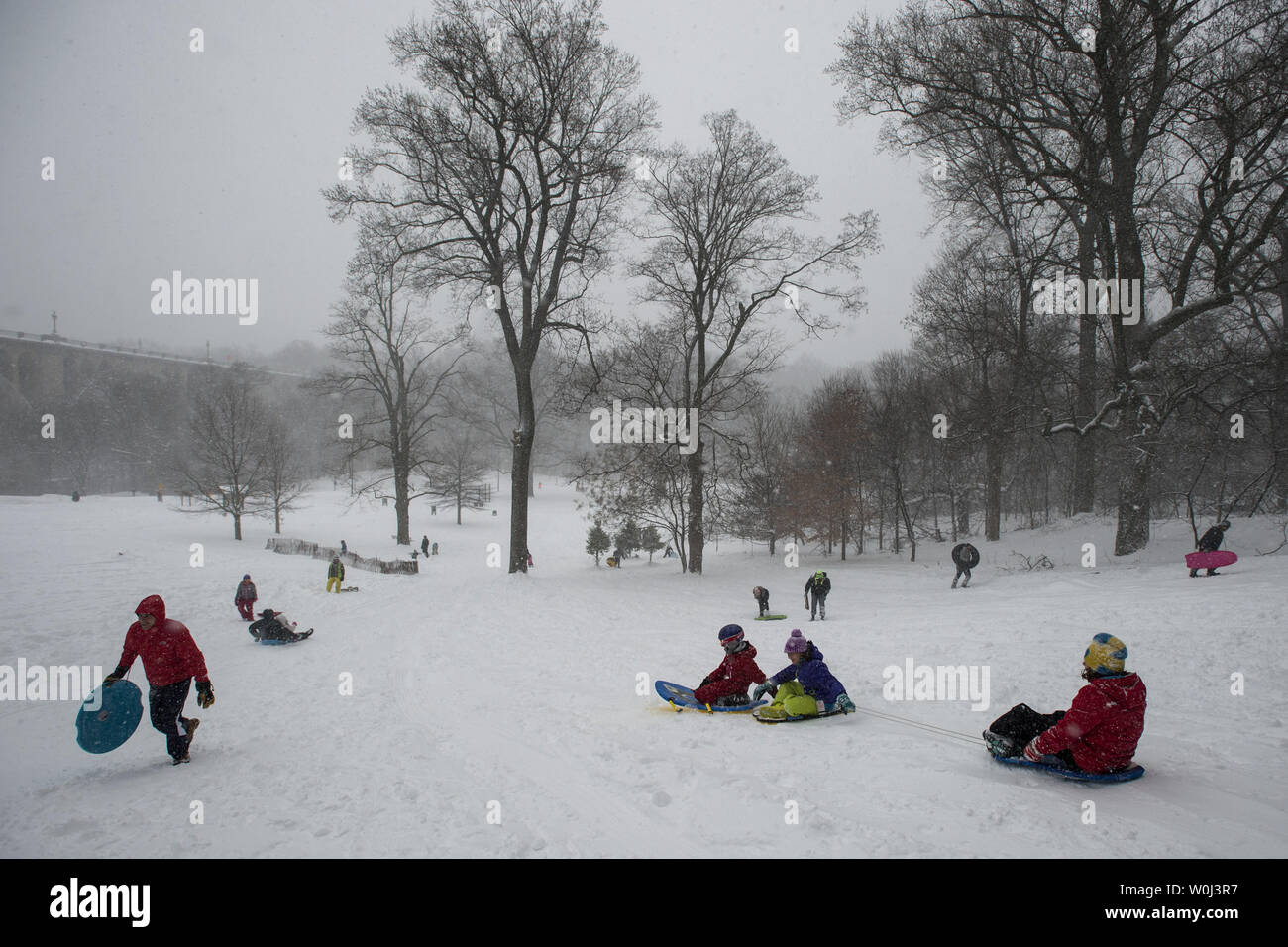 Rock Creek Park makes for an idyllic setting for a sled ride during a break of a blizzard that will drop more than 20 inches of snow on the Nation's Capital on January 23, 2016.   The massive blizzard has brought most of the East Coast to a standstill with high winds and more than 30 inches of snow predicted in some areas.   Photo by Pat Benic/UPI Stock Photo