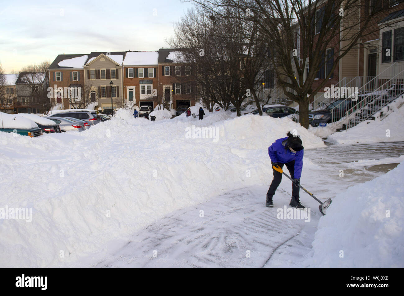 A woman shovels snow following this weekend's blizzard, in Centreville, Virginia on January 25, 2016. A deadly nor'easter blizzard blanketed parts of the east coast bringing near-record amounts of snow, shutting down Washington, Philadelphia and New York city. Photo by Kevin Dietsch/UPI Stock Photo