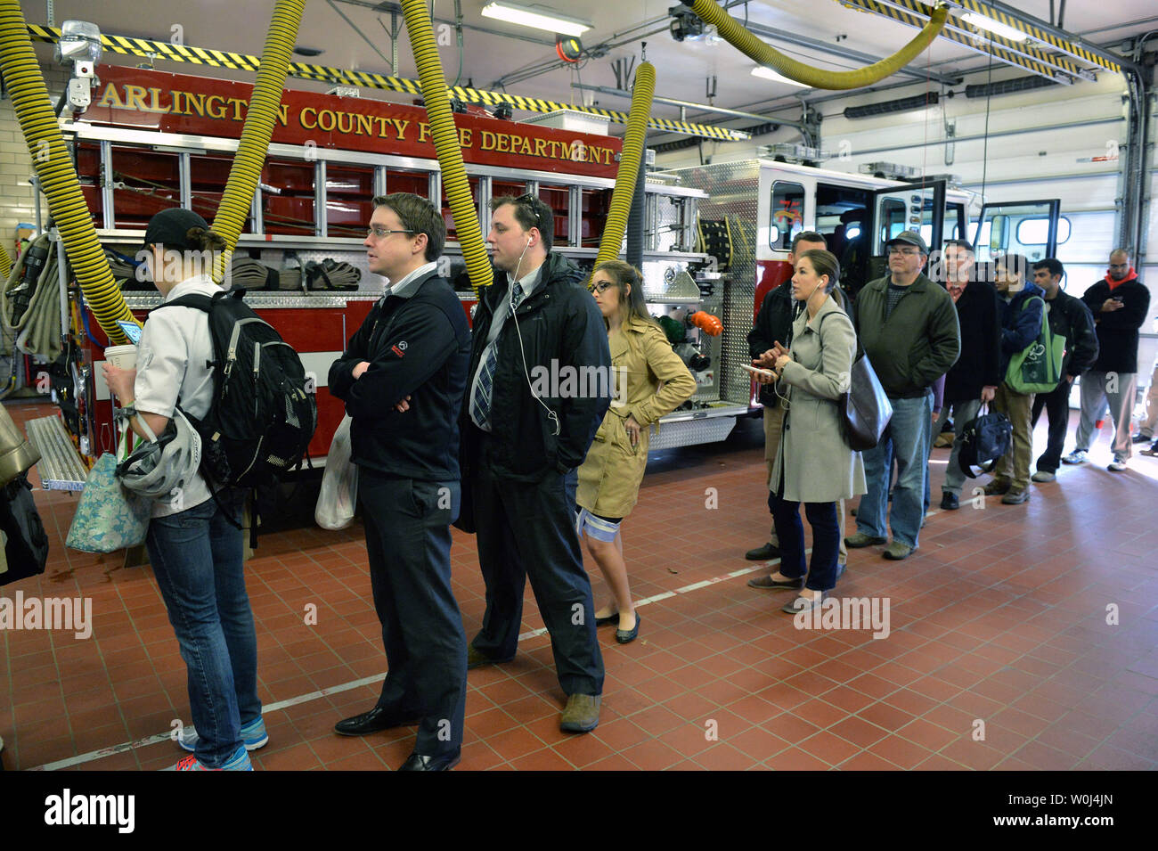 Voters wait in line to cast their ballots in the presidential primary ...