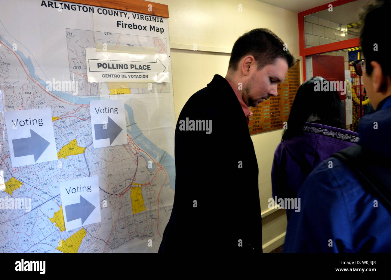 Voters wait in line to cast their ballots in the presidential primary ...