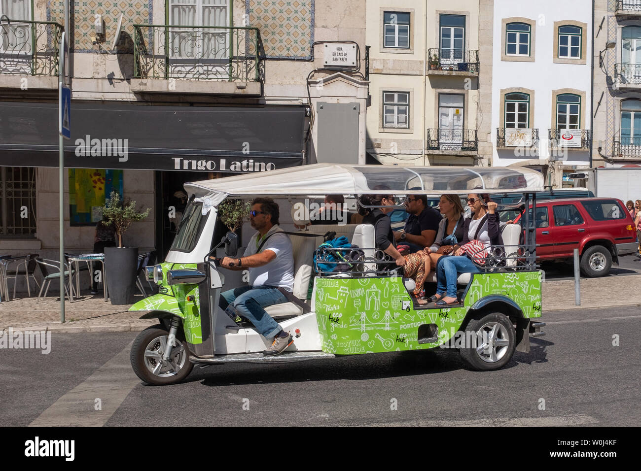Sightseeing tour with a three wheel tuk tuk-like tourist taxi in Lisbon, Portugal Stock Photo