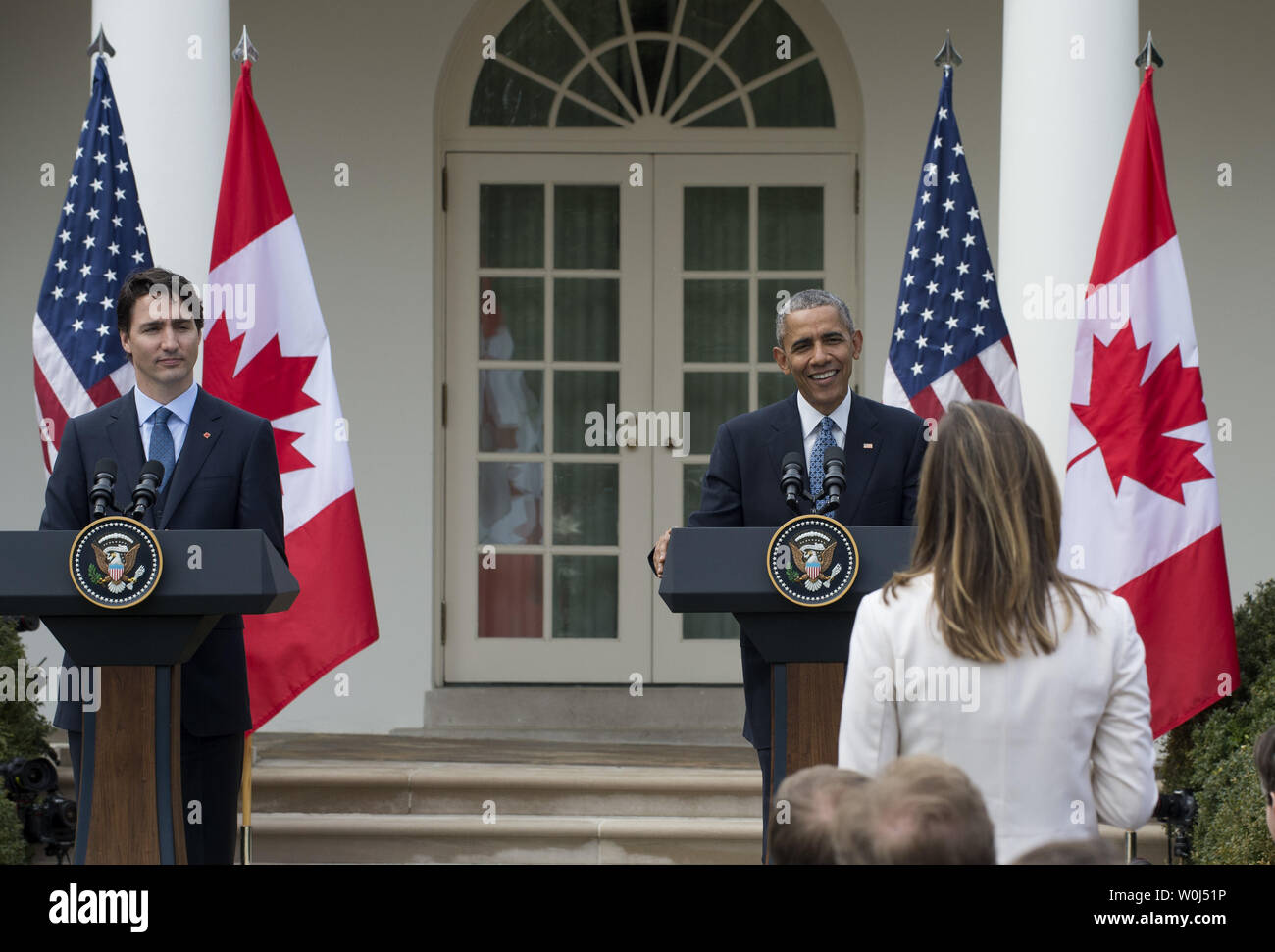 U.S. President Barack Obama and Canadian Prime Minister Justin Trudeau listen to a question from an American reporter at a joint press conference in the Rose Garden during the State Visit of the Canadian PM at the White House in Washington, DC on March 10, 2016.  Obama was smiling since the question related to Americans leaving for Canada if their candidate does not win in November.      Photo by Pat Benic/UPI Stock Photo