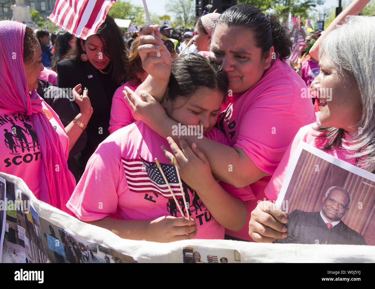 Protesters hugs outside of the Supreme Court as the Court hears oral arguments in the case of United States v. Texas, which will consider a legal challenge to the Deferred Action for Parents of Americans (DAPA) program and the expansion of the Deferred Action for Childhood Arrivals (DACA) program, in Washington, D.C. on April 18, 2016. Photo by Kevin Dietsch/UPI Stock Photo
