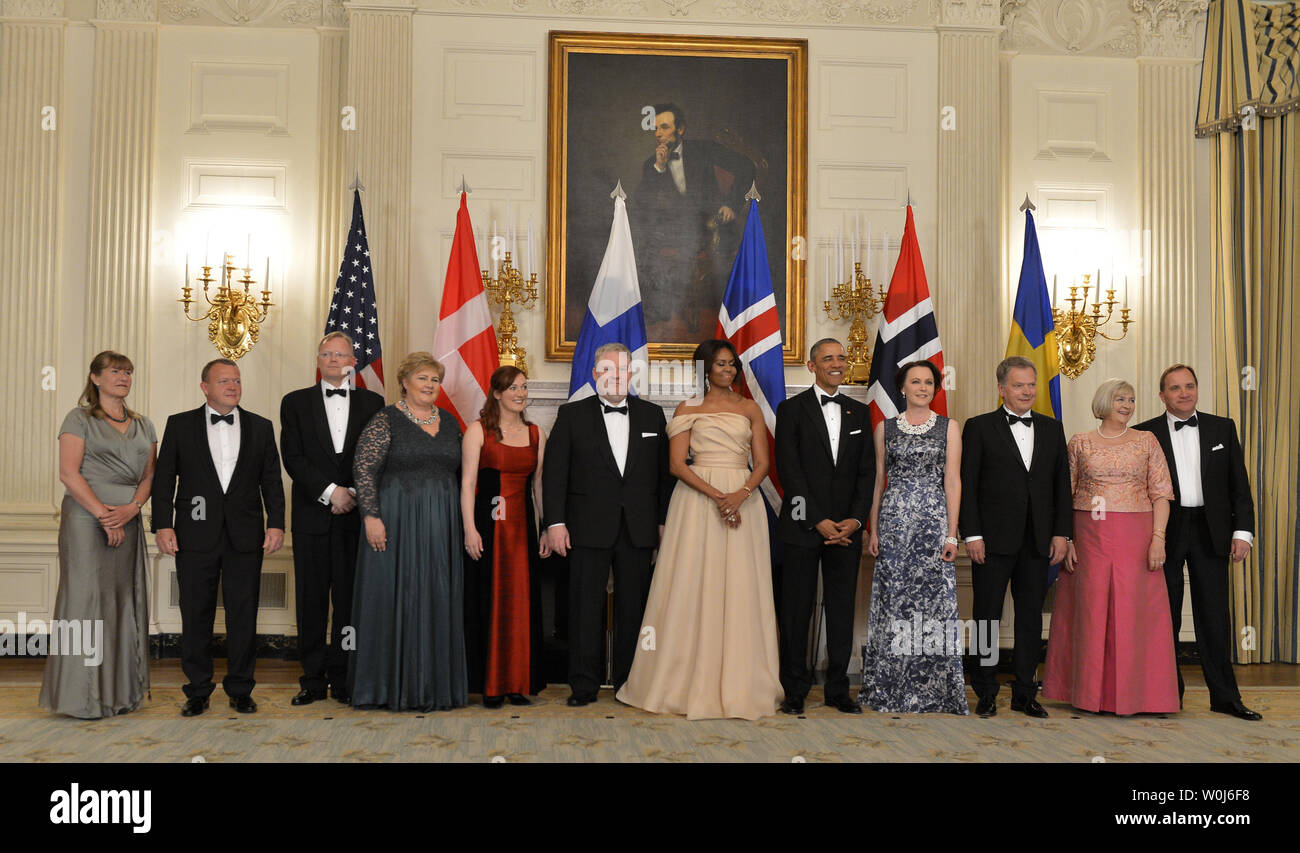 Elsa Rasmussen U.S.President Barack Obama and First Lady Michelle Obama (C) pose with ...