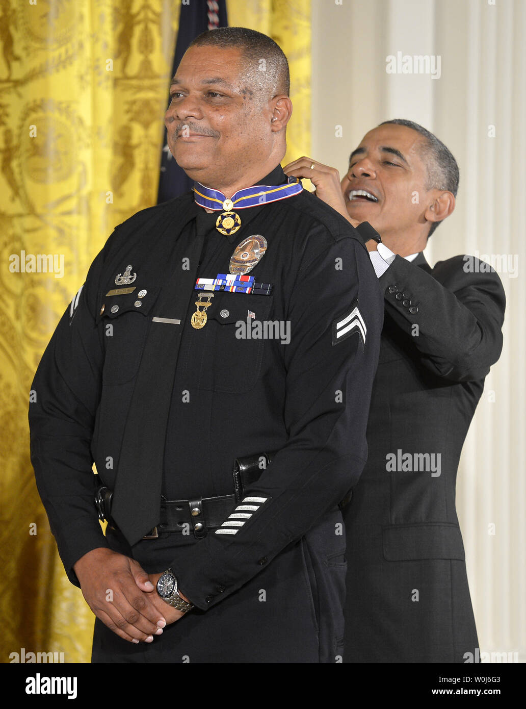 U.S.President Barack Obama (R) places a Medal of Valor around the neck of Los Angeles Police Dept. Officer Donald Thompson during a ceremony in the East Room of the White House, May 16, 2016, in Washington, DC. The honor is given to public safety officers who display exceptional courage in the performance of their duties.                Photo by Mike Theiler/UPI Stock Photo