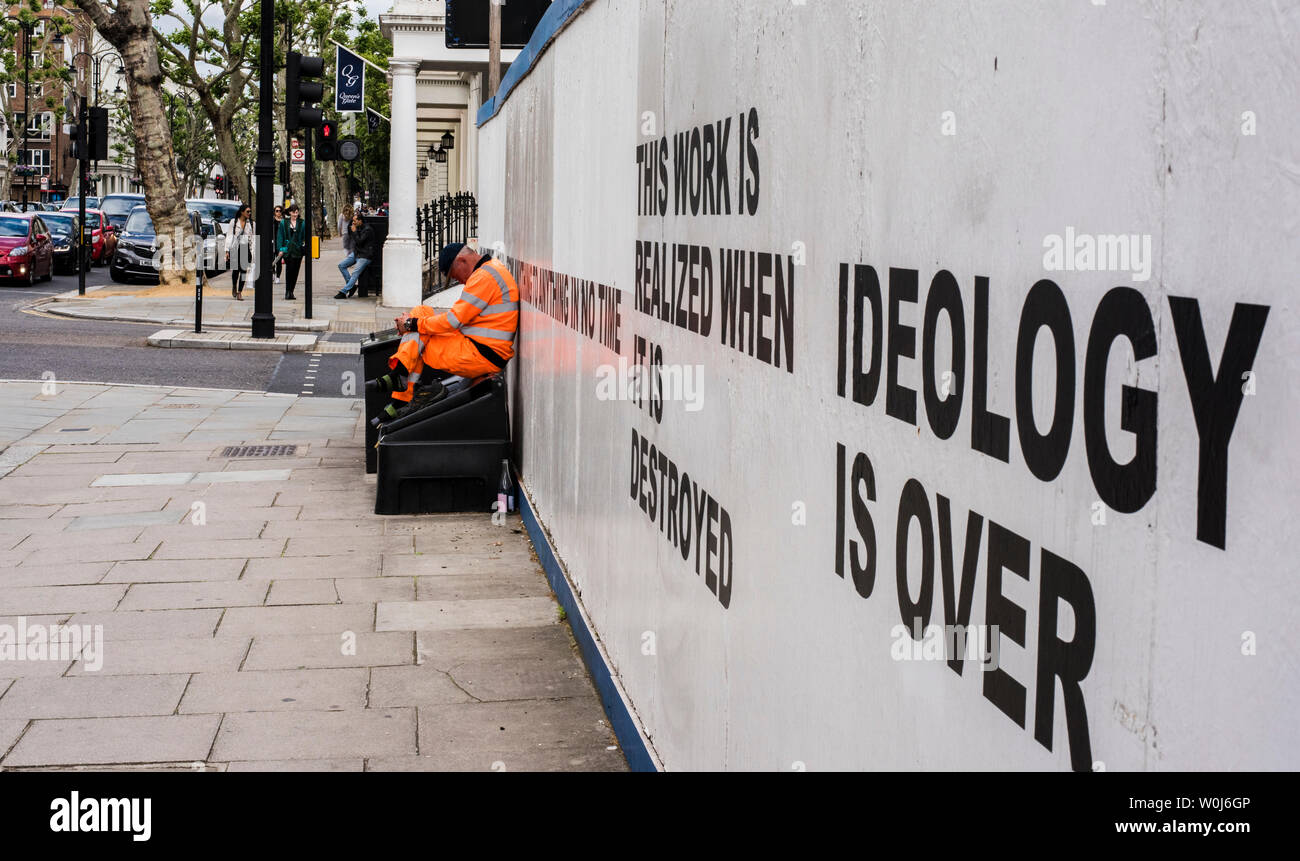 Construction worker in hi vis clothing sitting outside construction site, London, England, UK Stock Photo