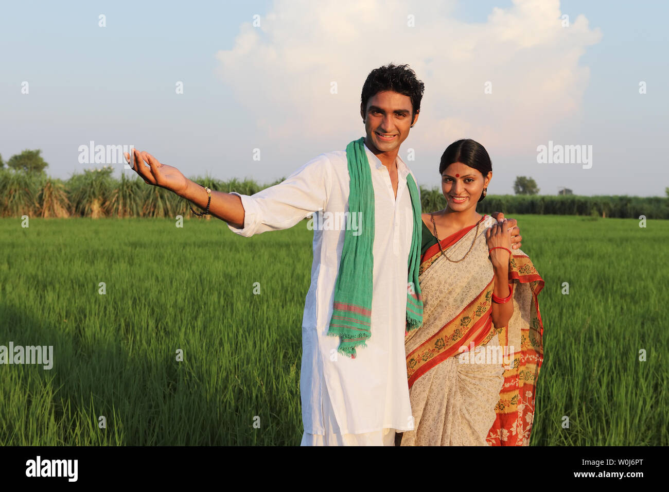 Farmer standing in a field with his wife Stock Photo Alamy