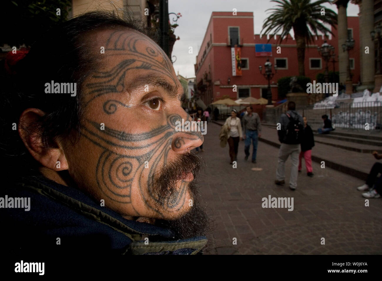 Portrait of tattoos on the profile face of a dark-skinned man in the  streets of Guanajuato capital in Mexico, during the Cervantino festival.  eye, mustache, beard, look, look, looking. (Photo: LuisGutierrez) Retrato
