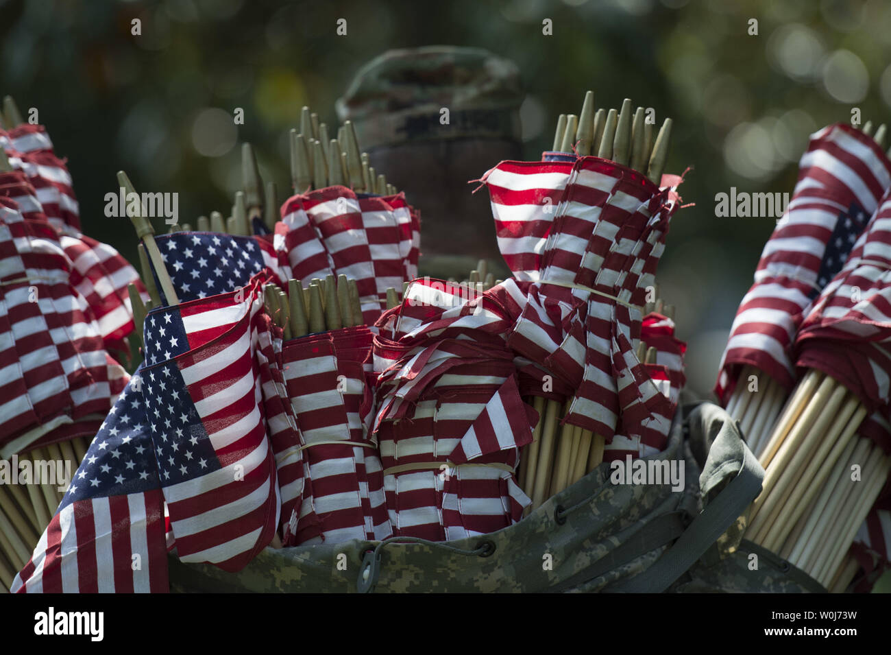 A soldier with the U.S. Army 3rd Infantry Regiment (Old Guard) carries flags during the annual Flags-In event for Memorial Day at Arlington National Cemetery in Arlington, Virginia on May 26, 2016. Members of The Old Guard placed an America flag at more than 230,000 grave markers at Arlington in honor of of Nation's fallen military members. The tradition has been conducted since 1948. Photo by Kevin Dietsch/UPI Stock Photo