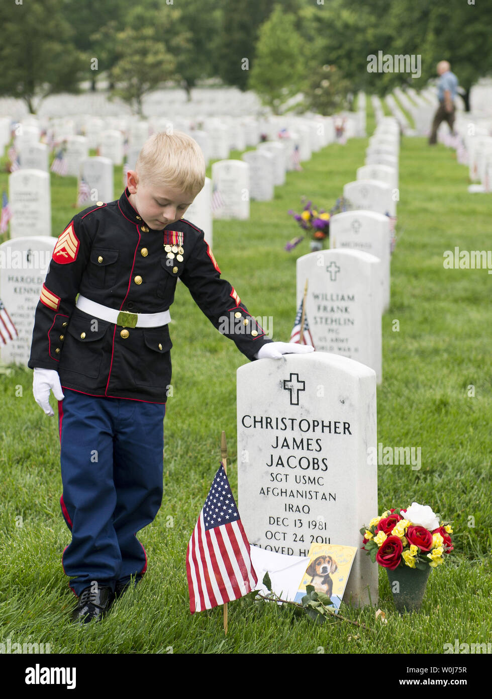 Christian Jacobs, 5, visits the grave of his father Marine Sgt. Christopher Jacobs at Arlington
