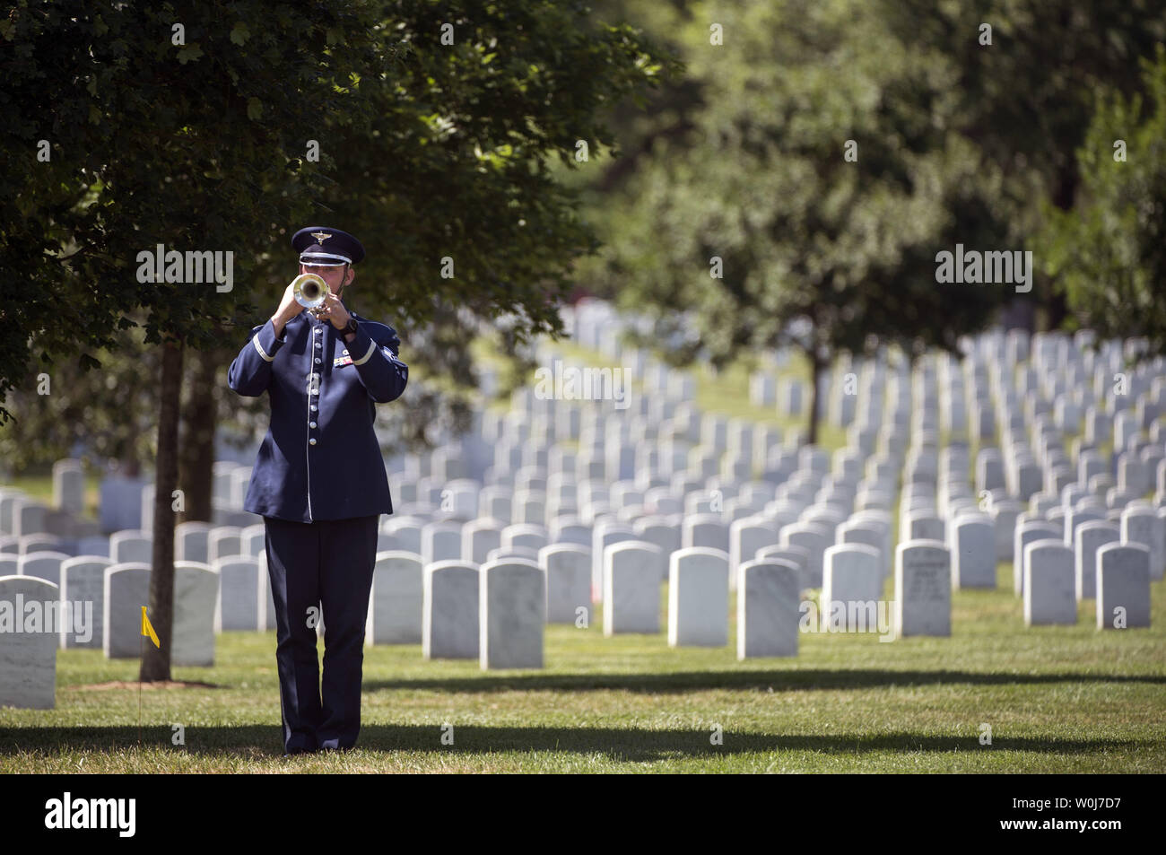 An Air Force Honor Guard bugler plays Taps during the funeral service for U.S. Air Force 2nd Lt., Malvin Greston 'Mal' Whitfield, at Arlington National Cemetery in Arlington, Virginia on June 8, 2016. Whitfield served in the U.S. Army Air Forces in 1943 as a member of the Tuskegee Airmen and was also a five-time Olympic medalist, including three gold. Photo by Kevin Dietsch/UPI Stock Photo