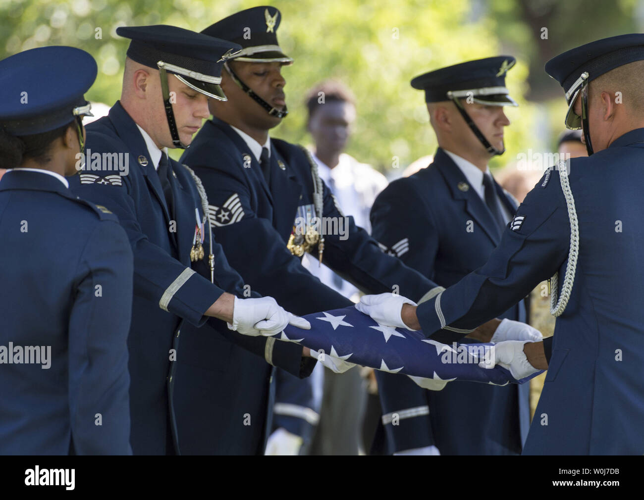 An Air Force Honor Guard folds an American flag during the funeral service for U.S. Air Force 2nd Lt., Malvin Greston 'Mal' Whitfield, at Arlington National Cemetery in Arlington, Virginia on June 8, 2016. Whitfield served in the U.S. Army Air Forces in 1943 as a member of the Tuskegee Airmen and was also a five-time Olympic medalist, including three gold. Photo by Kevin Dietsch/UPI Stock Photo