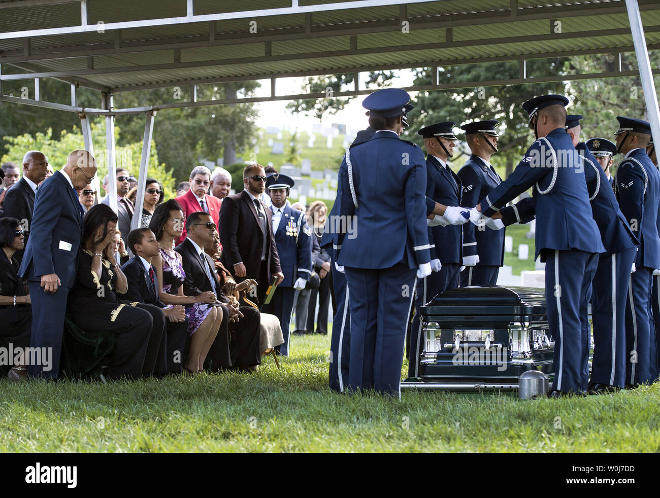 An Air Force Honor Guard folds an American flag during the funeral service for U.S. Air Force 2nd Lt., Malvin Greston 'Mal' Whitfield, at Arlington National Cemetery in Arlington, Virginia on June 8, 2016. Whitfield served in the U.S. Army Air Forces in 1943 as a member of the Tuskegee Airmen and was also a five-time Olympic medalist, including three gold. Photo by Kevin Dietsch/UPI Stock Photo