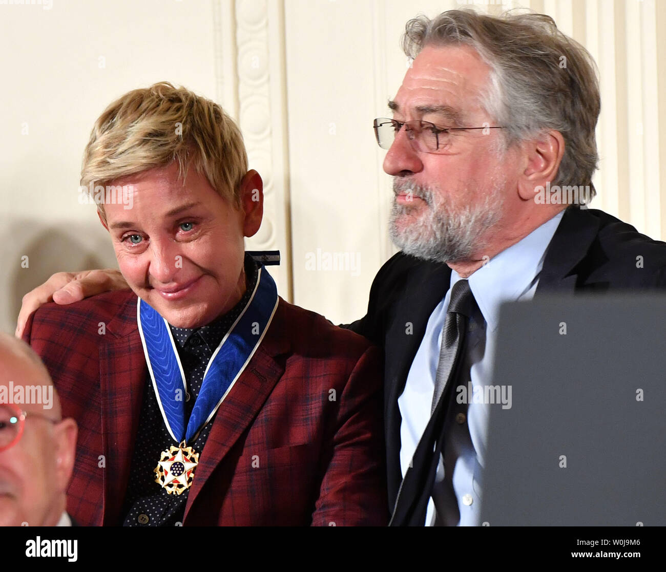 Actor Robert De Nero hugs comedian Ellen DeGeneres after President Barack  Obama awarded her the Presidential Medal of Freedom, during a ceremony at  the White House in Washington, D.C. on November 22,