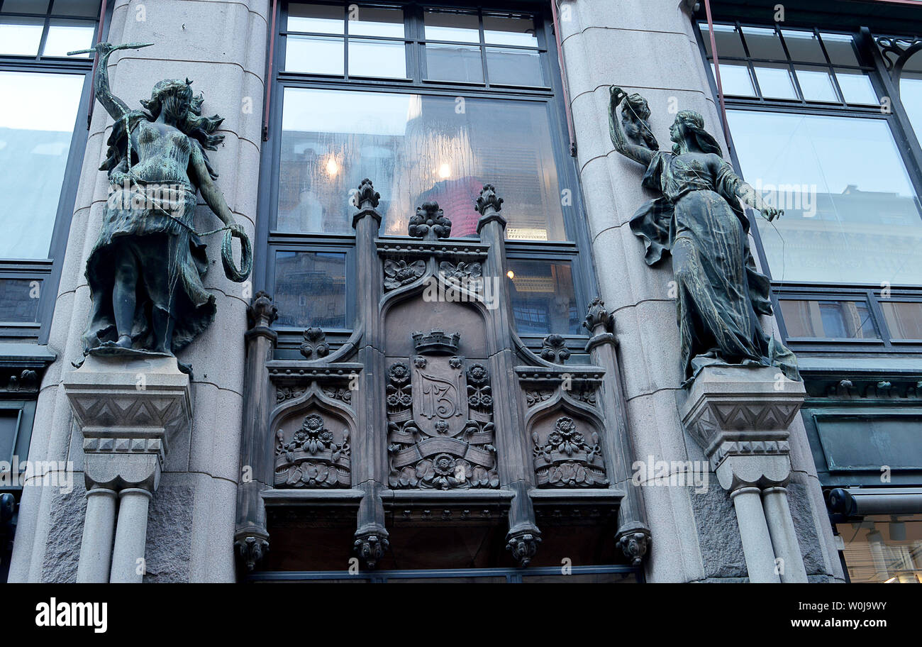 HELSINKI, FINLAND - 7 APRIL 2019: Statues at entrance of Aleksanterinkatu 13 which gives its name to the current occupant, clothing chain Aleksi 13. Stock Photo