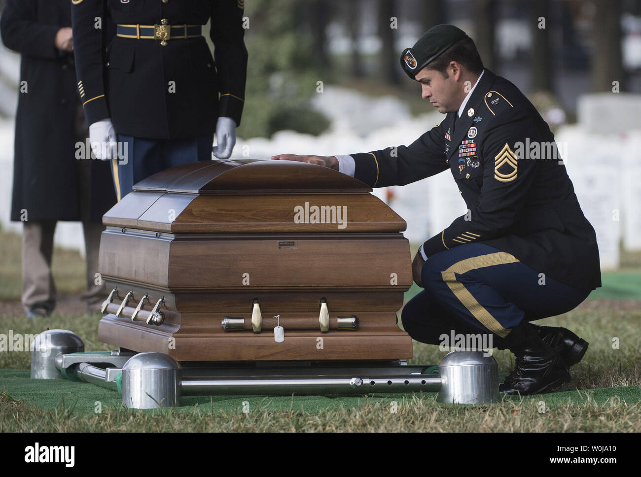 A member of the Army Special Forces pays respects to Army Staff Sergeant  Kevin McEnroe during his funeral at Arlington National Cemetery in  Arlington, Virginia on December 5, 2016. McEnroe, and two