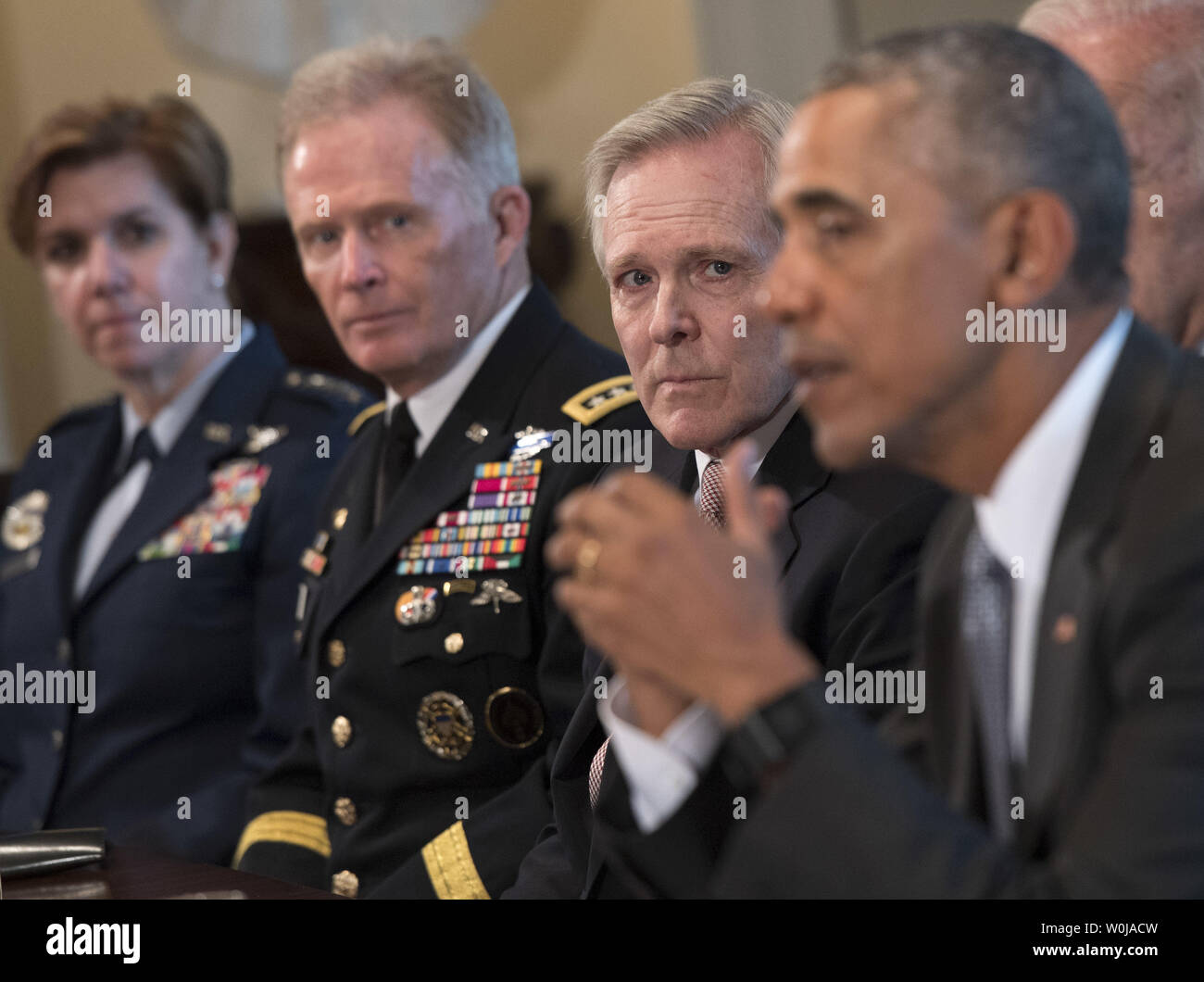 Navy Secretary Ray Mabus Listens As President Barack Obama Speaks