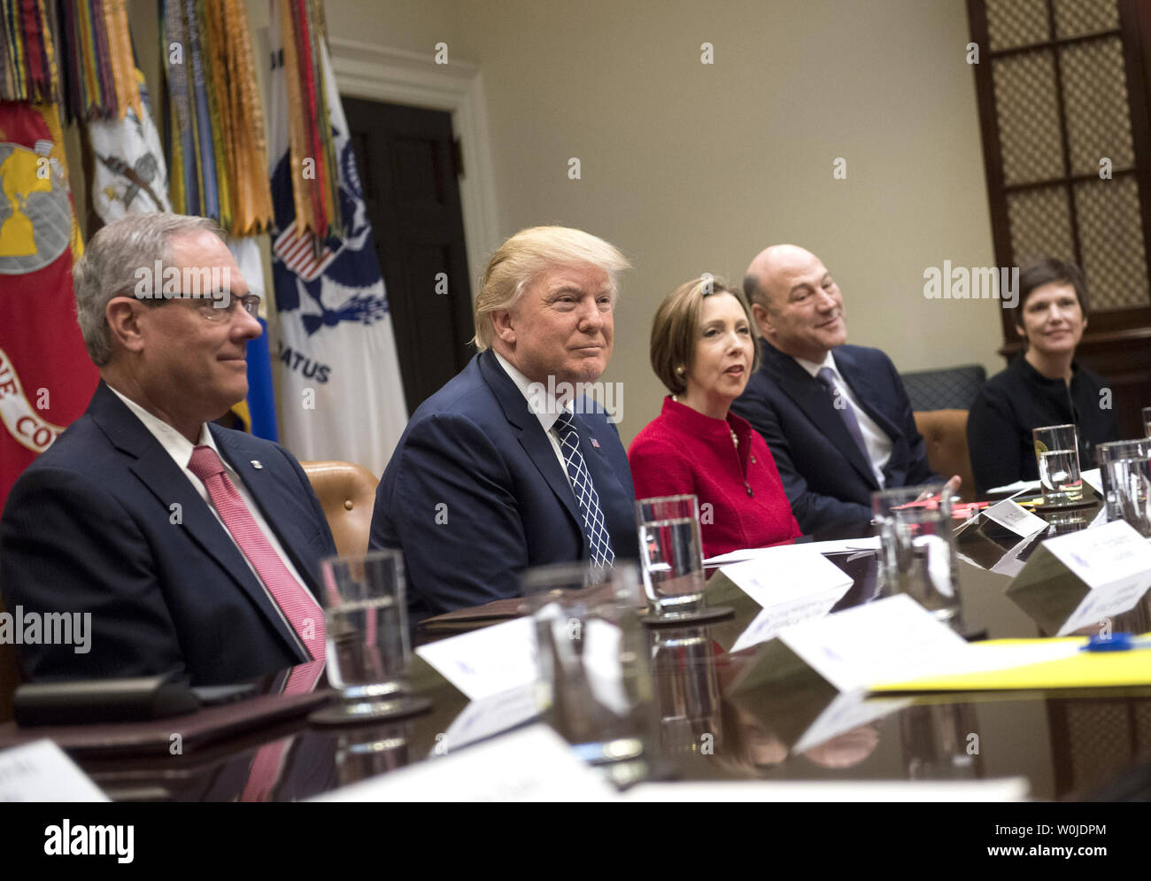 President Donald Trump (2nd-L) holds a National Economic Council listening session with the CEOs of small and community banks, in the Roosevelt Room at the White House in Washington, D.C. on March 9, 2017. Trump was joined by Kenneth Burgess (L), Chairman of the First Capital Bank of Texas; Dorothy Savarese, CEO of Cape Cod Five Mutual Company (C); Gary Cohn, National Economic Council Director; and Leslie Anderson, CEO of Bank of Bennington. Photo by Kevin Dietsch/UPI Stock Photo