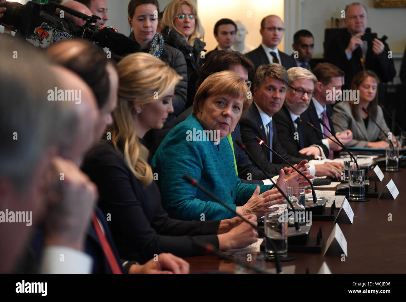 German Chancellor Angela Merkel (C), with Ivanka Trump (left center), speaks during a roundtable discussion on vocational training with United States and German business leaders, lead by President Donald Trump (not seen), in the Cabinet Room of the White House in Washington, DC on March 17, 2017.       Photo by Pat Benic/UPI Stock Photo