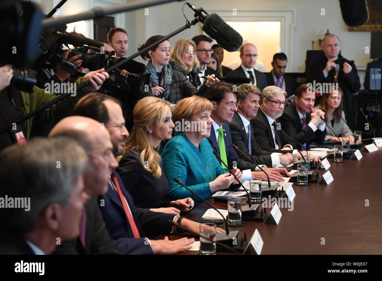 German Chancellor Angela Merkel (C) and Ivanka Trump (left center) particapate in a roundtable discussion on vocational training with United States and German business leaders, lead by President Donald Trump (not seen) in the Cabinet Room of the White House in Washington, DC on March 17, 2017.       Photo by Pat Benic/UPI Stock Photo