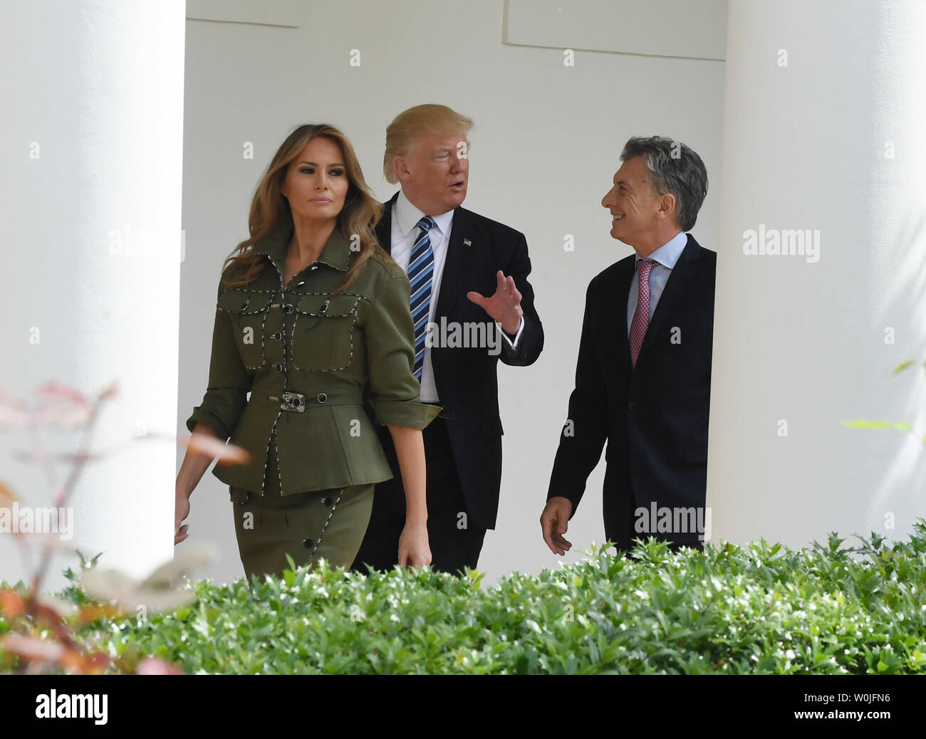 U.S. President Donald Trump and Argentine President Mauricio Macri chat as they walk along the colonnade of the White House with their wives First Lady Melania and Juliana Awada  to the Oval Office after arrival in Washington, DC on April 27, 2017.  Macri is in town for talks with Trump.     Photo by Pat Benic/UPI Stock Photo