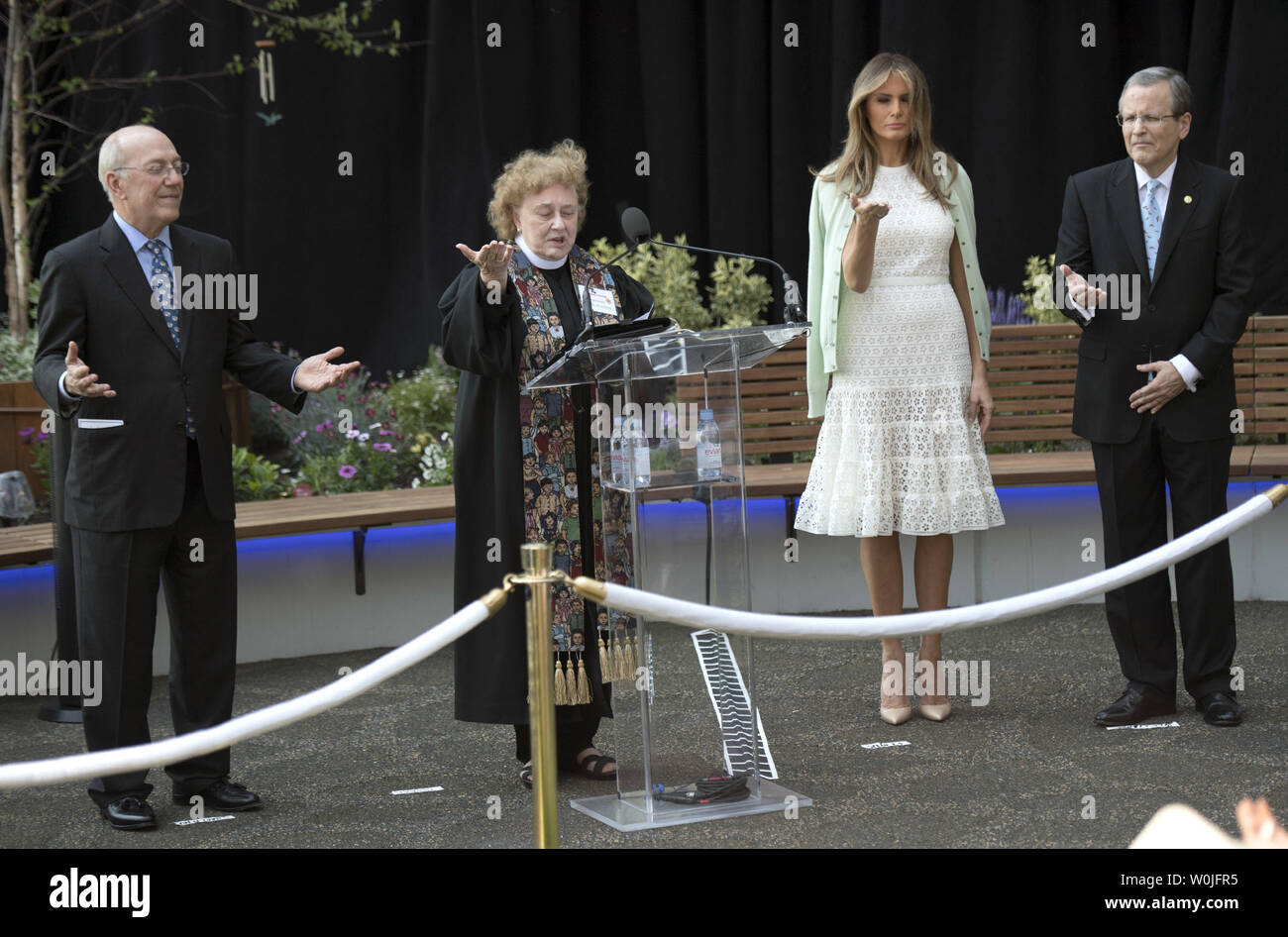 First Lady Melania Trump (2nd-R), Michael Williams (R), Chairman of the board, Kurt Newman, President and CEO, participate in a blessing by Reverend Kathleen Ennis-Durstine, at the opening ceremony of the Bunny Mellon Healing Garden, dedicated to the First Ladies of the United States, at Children's National Hospital in Washington, D.C. on April 28, 2017.  The hospital transformed a gravel rooftop into an outdoor garden for patients and their families. Photo by Kevin Dietsch/UPI Stock Photo