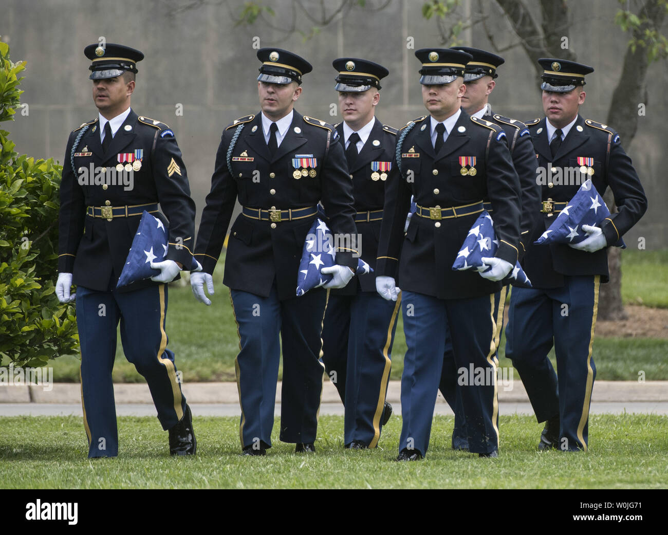 Members of an Honor Guard with the Army's 3rd Infantry Regiment (The Old Guard) carry flags during Army Staff Sergeant Mark De Alencar's funeral at Arlington National Cemetery in Arlington, Virginia on May 10, 2017. Alencar was killed in combat operations in Afghanistan. Photo by Kevin Dietsch/UPI Stock Photo