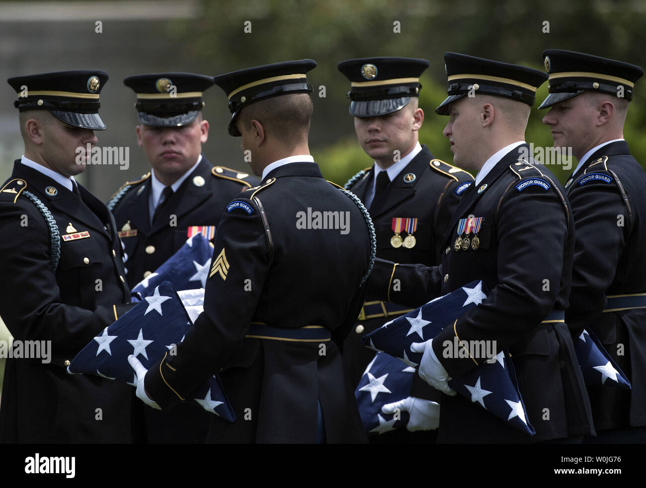 Members of an Honor Guard with the Army's 3rd Infantry Regiment (The Old Guard) wait for the start of Army Staff Sergeant Mark De Alencar's funeral at Arlington National Cemetery in Arlington, Virginia on May 10, 2017. Alencar was killed in combat operations in Afghanistan. Photo by Kevin Dietsch/UPI Stock Photo