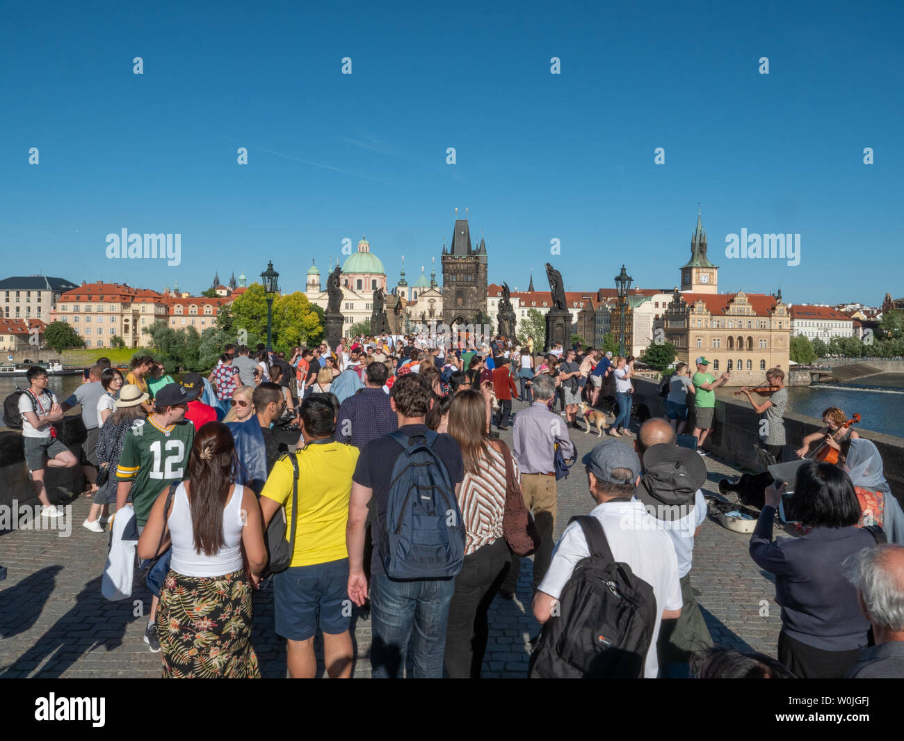 Prague, Czech Republic - June 8 2019: Tourist Masses and Crowds on Charles Bridge on the River Vltava on a hot summer day. A Concept for Mass Tourism. Stock Photo