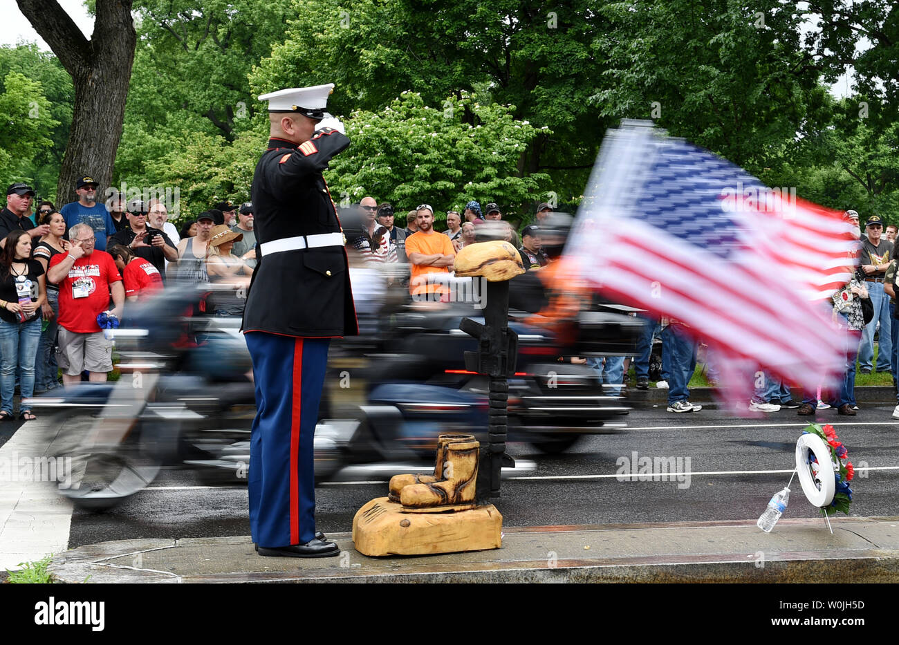 USMC SSgt. Tim Chambers salutes Rolling Thunder riders as participants in  the annual Rolling Thunder Ride